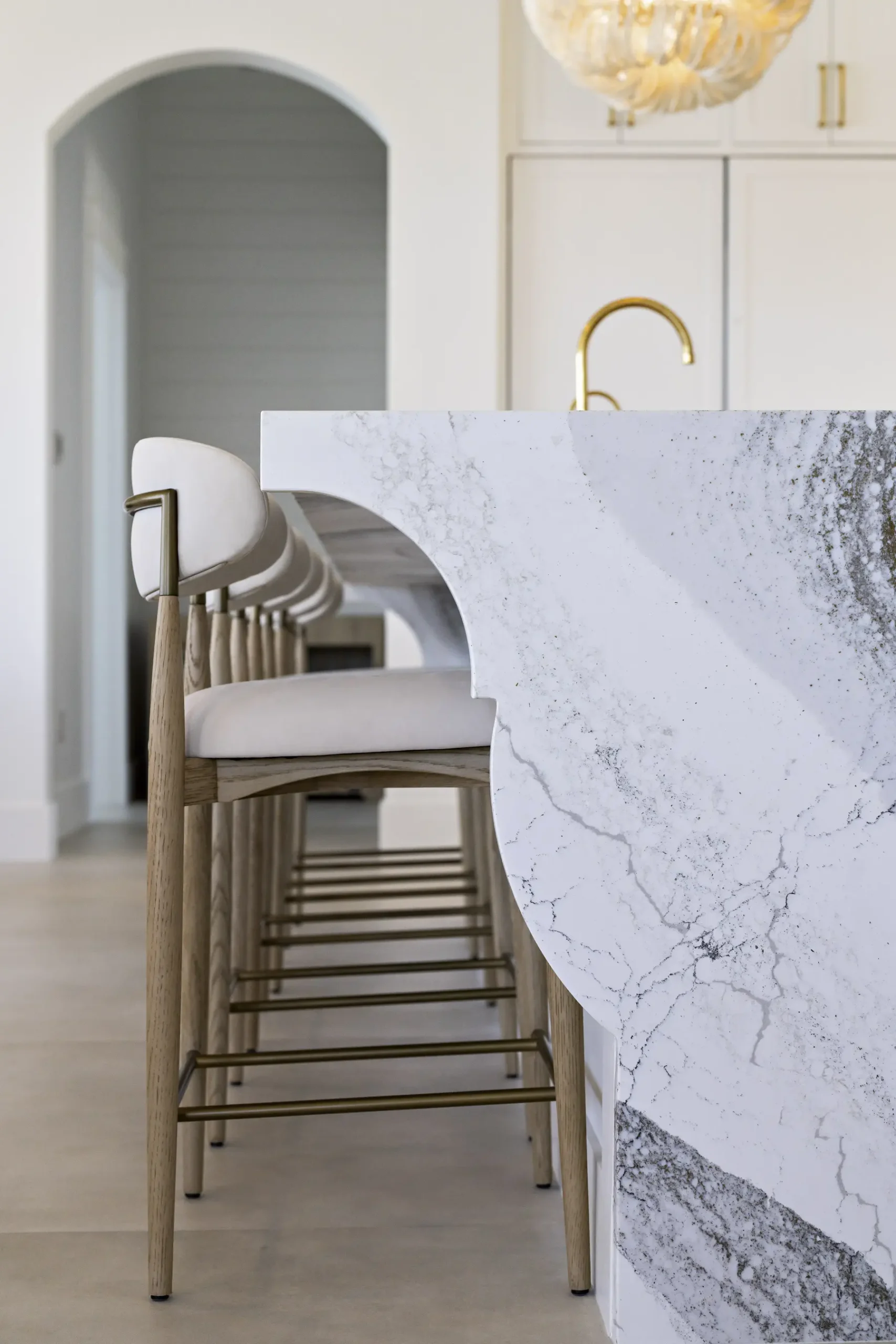 Marble waterfall island edge with counter stools