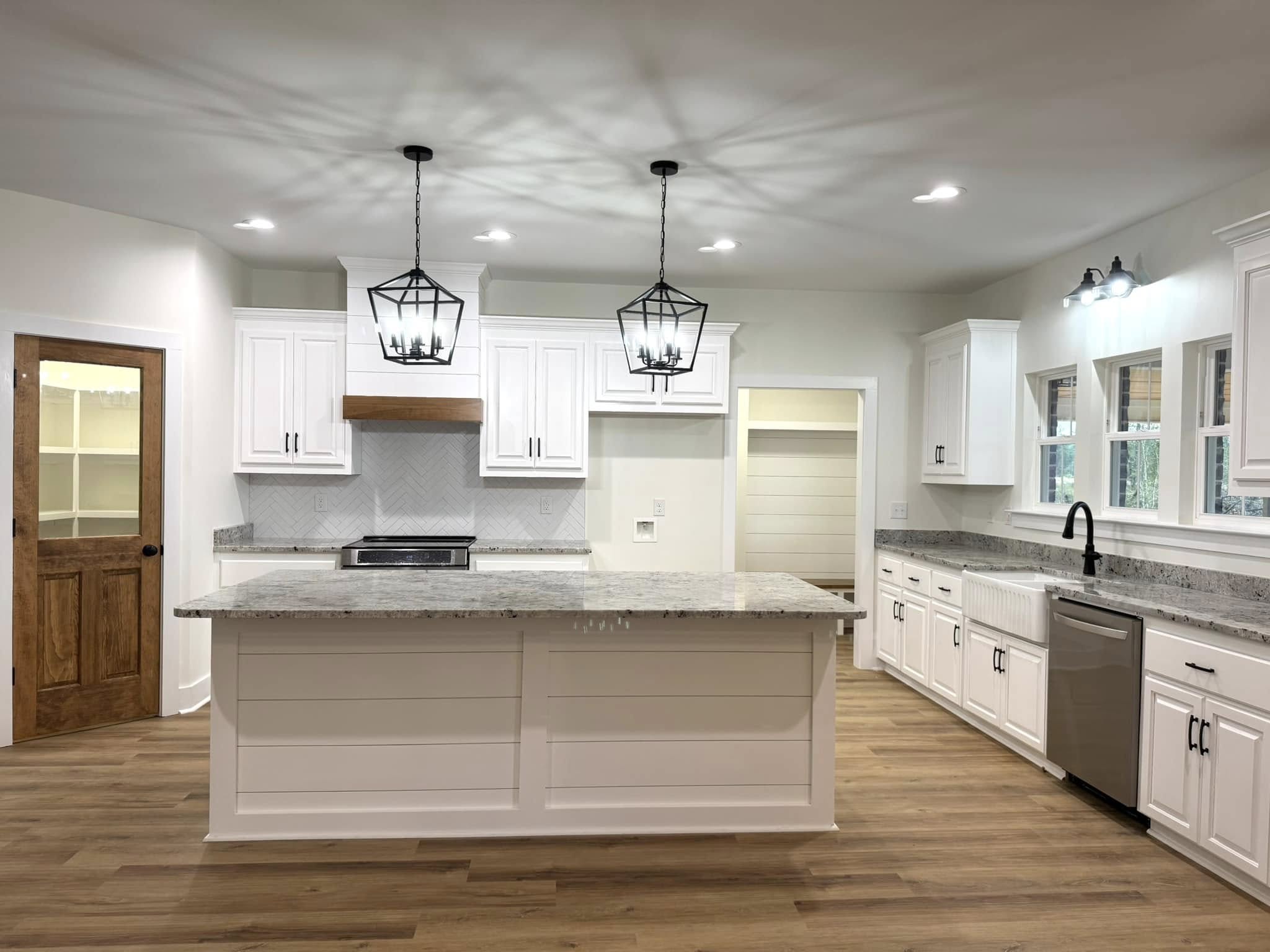 Granite kitchen countertops and island in a white shaker kitchen